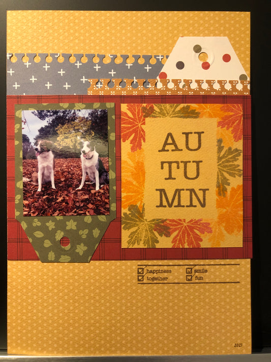 Autumn scrapbook layout inspiration featuring dogs in fall leaves with seasonal patterns and stamps