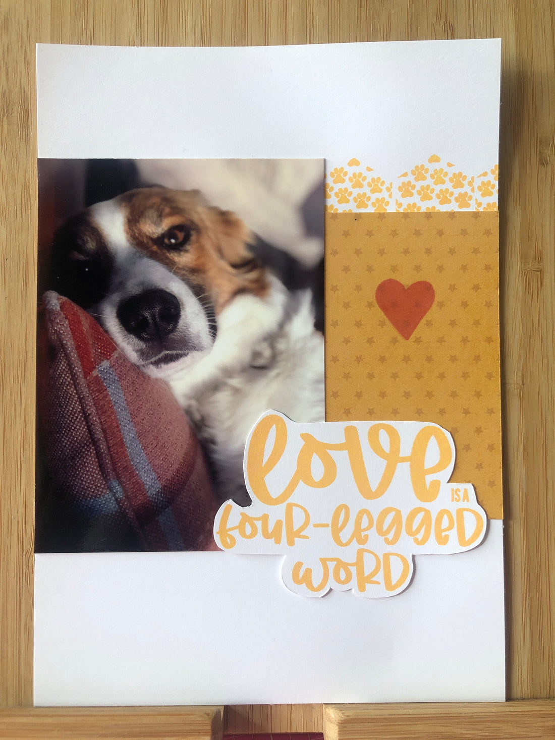 Pet love scrapbook layout with dog photo and four-legged word sentiment